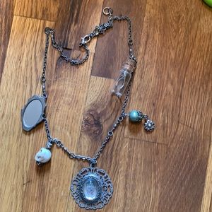 Necklace, with mirror, skull, rose and wishbone.